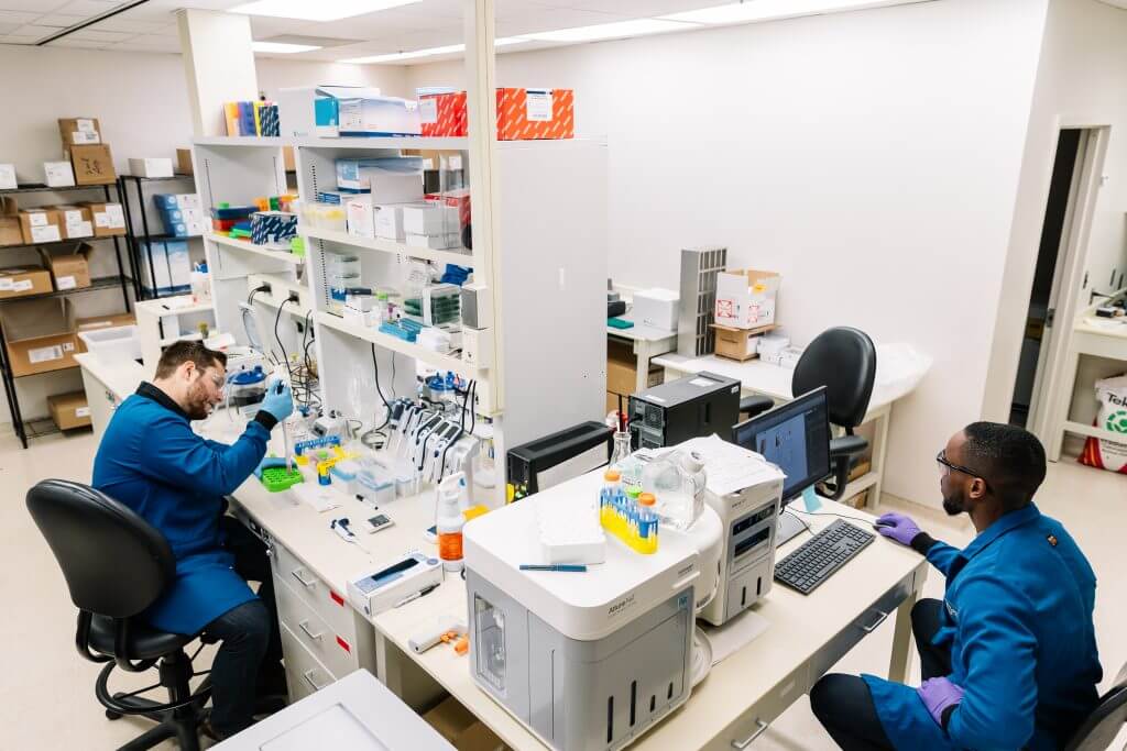 Scientists working at lab bench in Innovation Space full lab